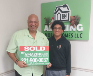 man and young kid new mobile home homeowners